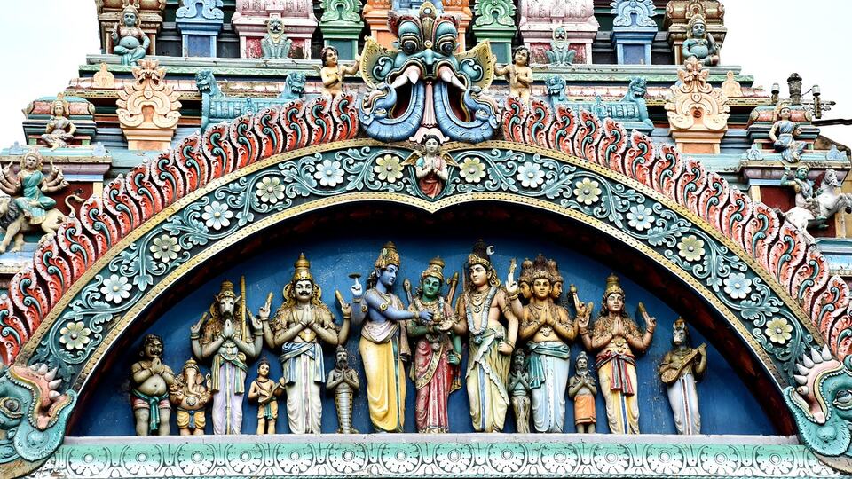 Brightly painted deities on a gopuram of Meenakshi Temple in Madurai