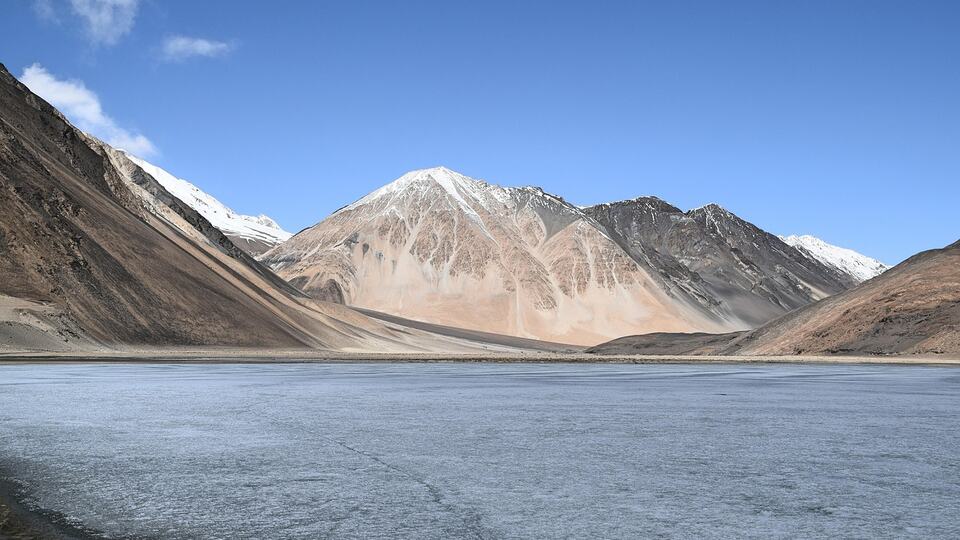 Pangong Lake surrounded by snow-streaked mountains in Ladakh