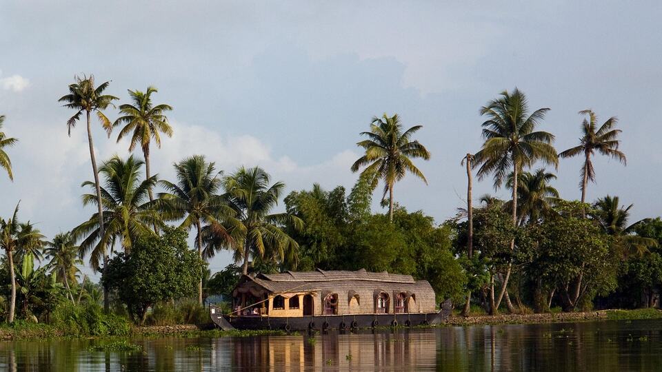 Traditional houseboat on the palm-fringed backwaters of Kerala