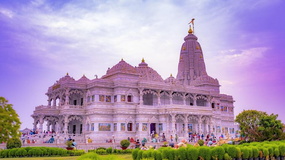 Prem Mandir temple in Vrindavan under a colourful evening sky
