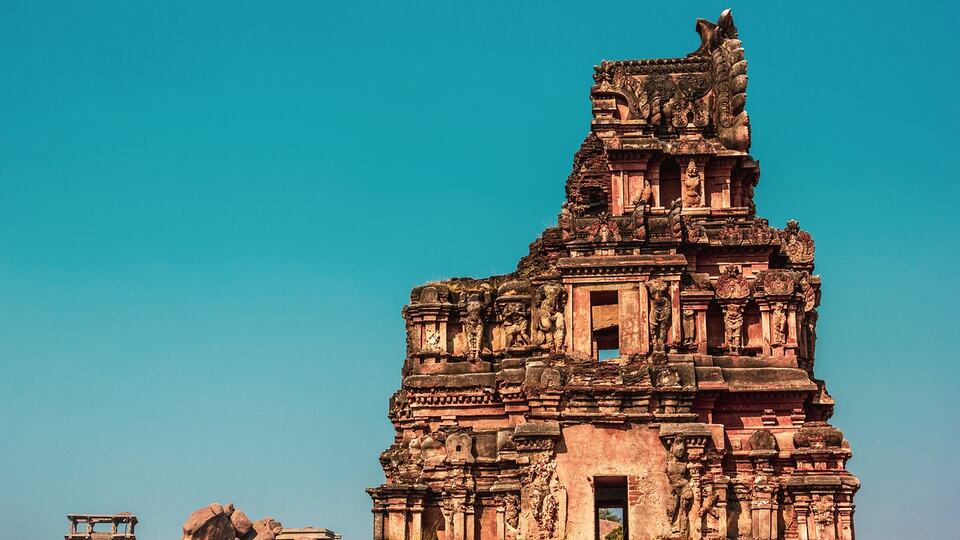 Carved stone tower of an ancient temple in Hampi, Karnataka