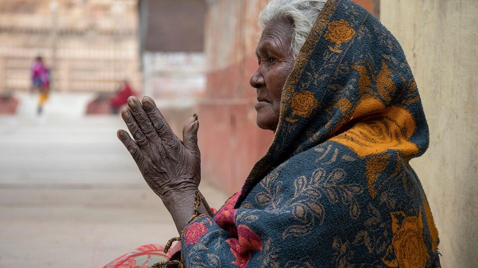 Elderly woman greeting with folded hands in the namaste gesture