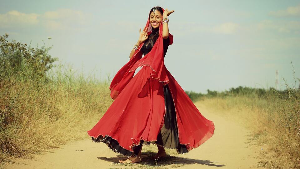 Dancer twirling in a flowing red traditional dress