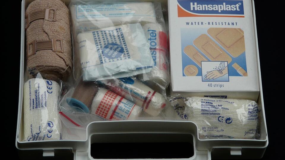 Open first-aid kit with plasters and bandages