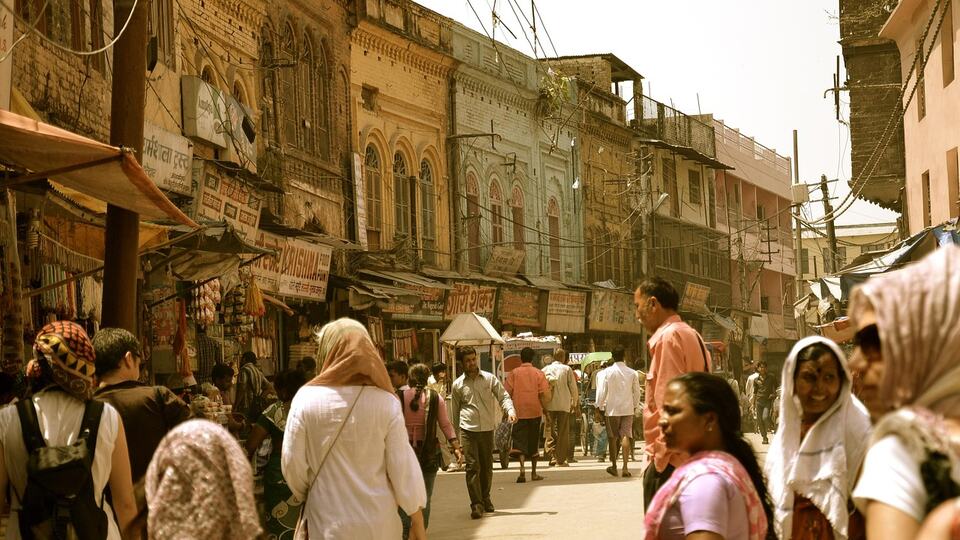 Crowded colourful market street in Delhi with shoppers and shops