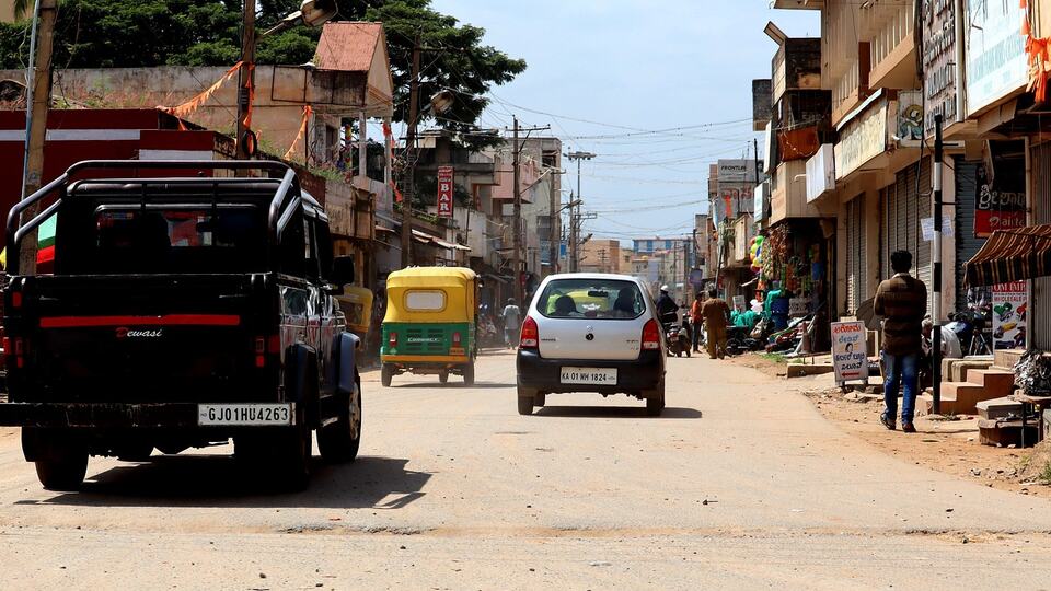 Auto-rickshaws and traffic on a busy Indian street