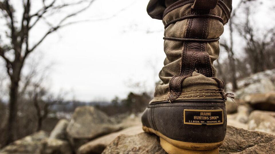 Sturdy trekking boot on rocky ground on a mountain trail