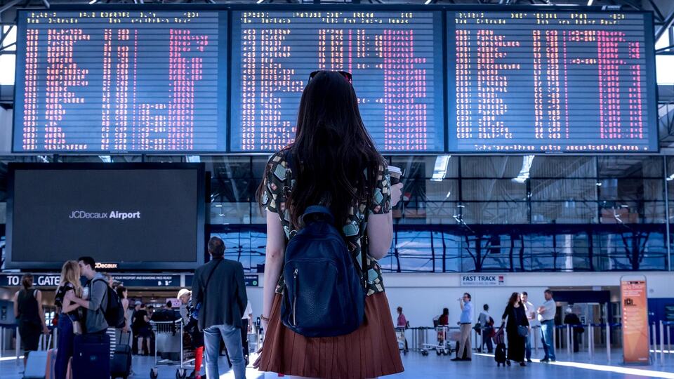 Traveller with luggage walking through an airport terminal