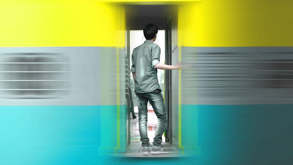 Traveller boarding a colourful Indian train