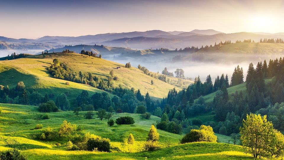 Misty green hills and valleys of India seen from a hilltop viewpoint