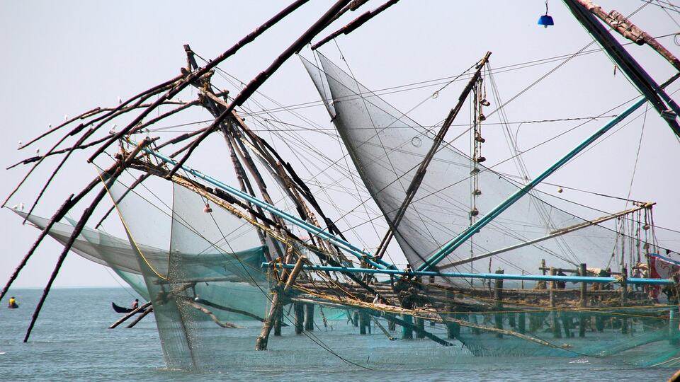 Chinese fishing nets silhouetted against the harbour of Fort Kochi