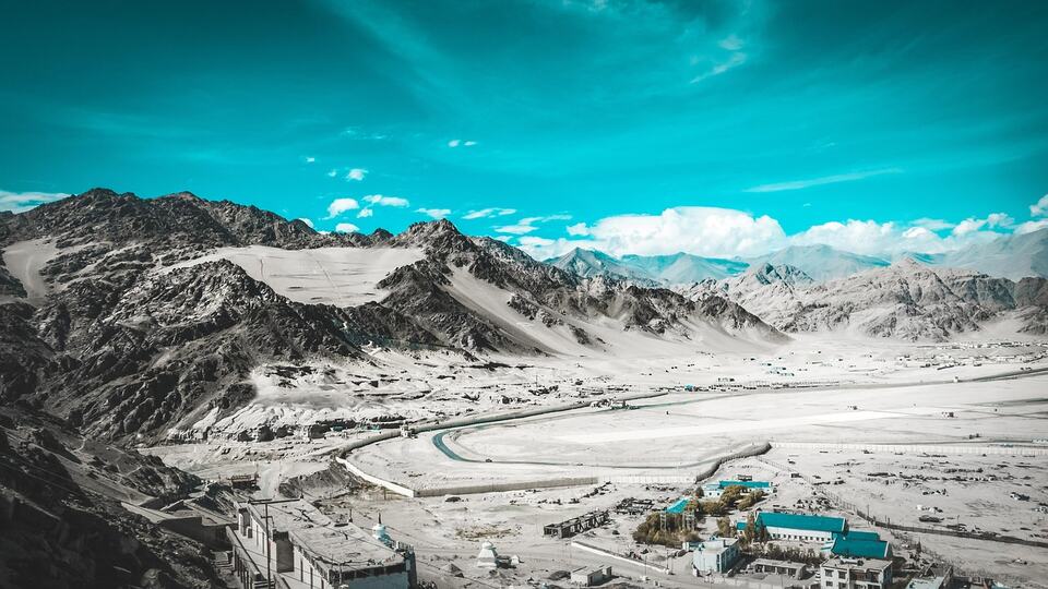 Snow-covered valley with a monastery settlement in the mountains of Ladakh