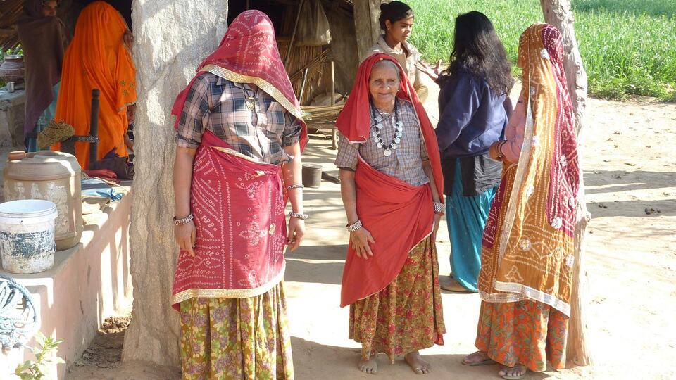 Women in colourful saris in a Rajasthani village