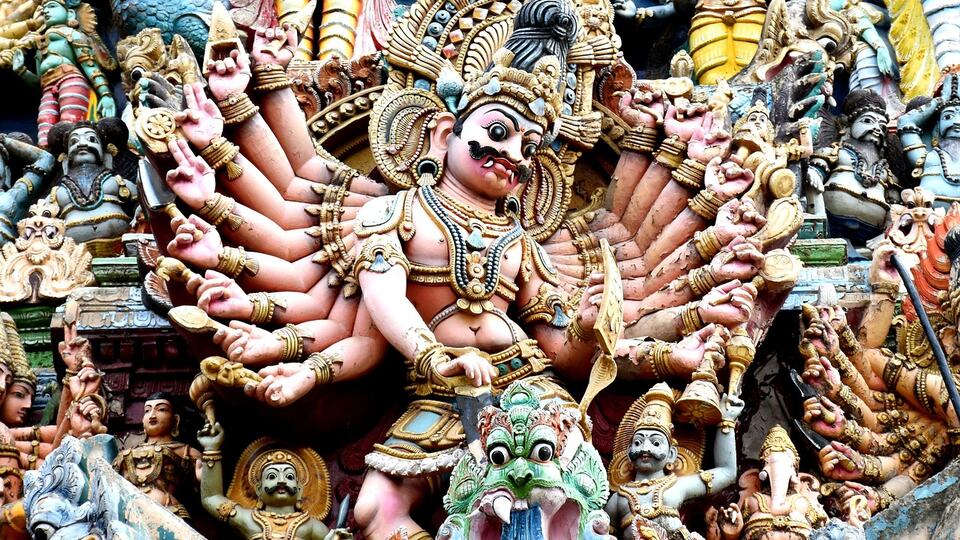 Brightly painted sculptures on a gopuram tower of Meenakshi Temple in Madurai
