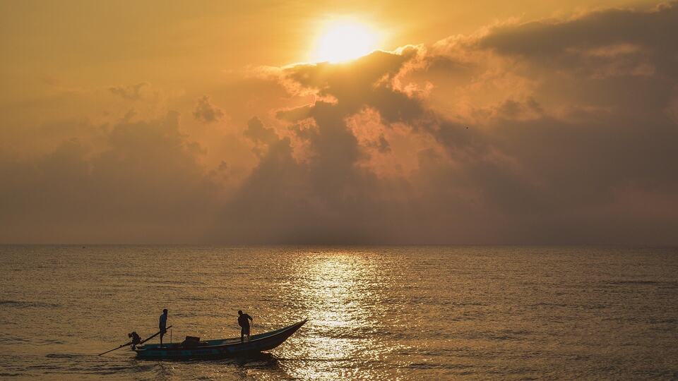 Fishing boat at sunrise off the coast of Puducherry