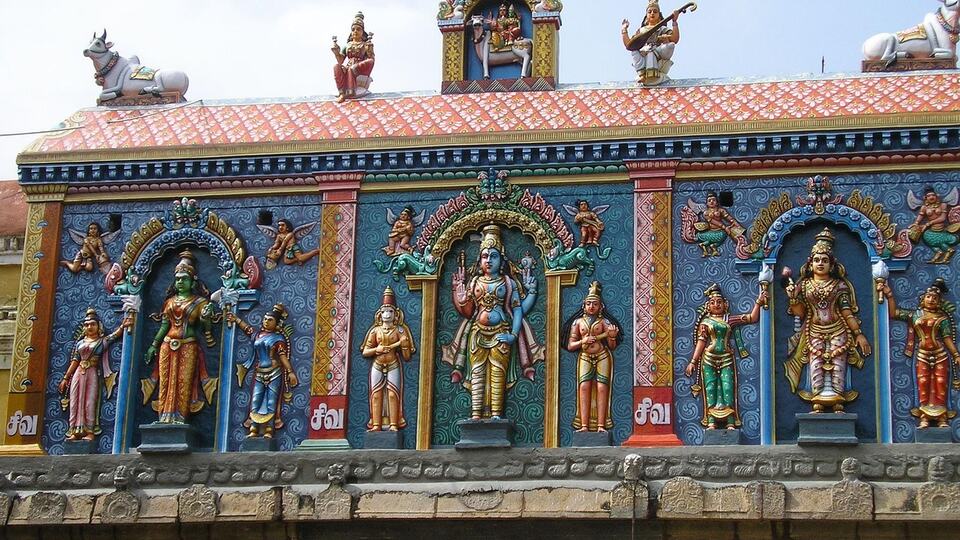 Painted frieze of Hindu deities on a temple wall in Thanjavur