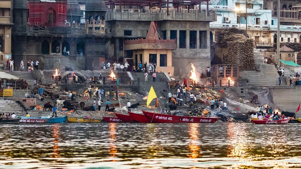 Pilgrims and boats on the ghats of Varanasi along the sacred Ganges River